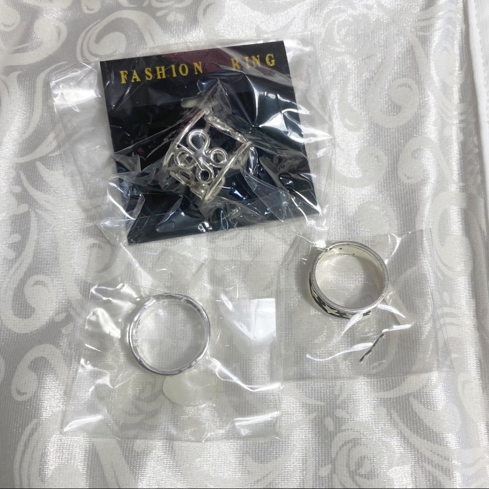 Ring Set 3 pc. Wide adjustable silvertone ring. Two thin bands size 6 silvertone